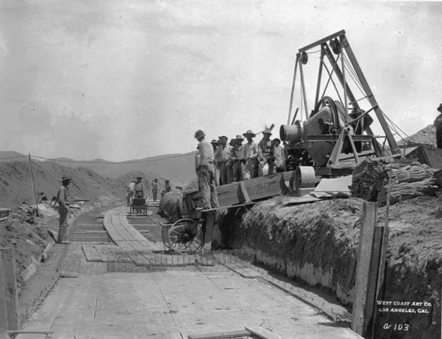 (1908)* - Workers begin the process of cement lining the open channel portion of the LA Aqueduct.