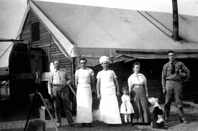 (ca. 1912)^*โ View showing some of the cooks and possibly family posing in front of the mess hall.