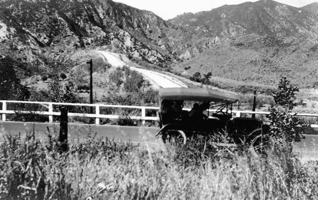 (ca. 1920s)^.^ โ An early model car stops in front of the Los Angeles Aqueduct Cascades.